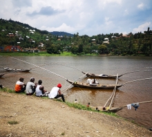 Men overlooking fishing boats on Lake Kivu, Rwanda